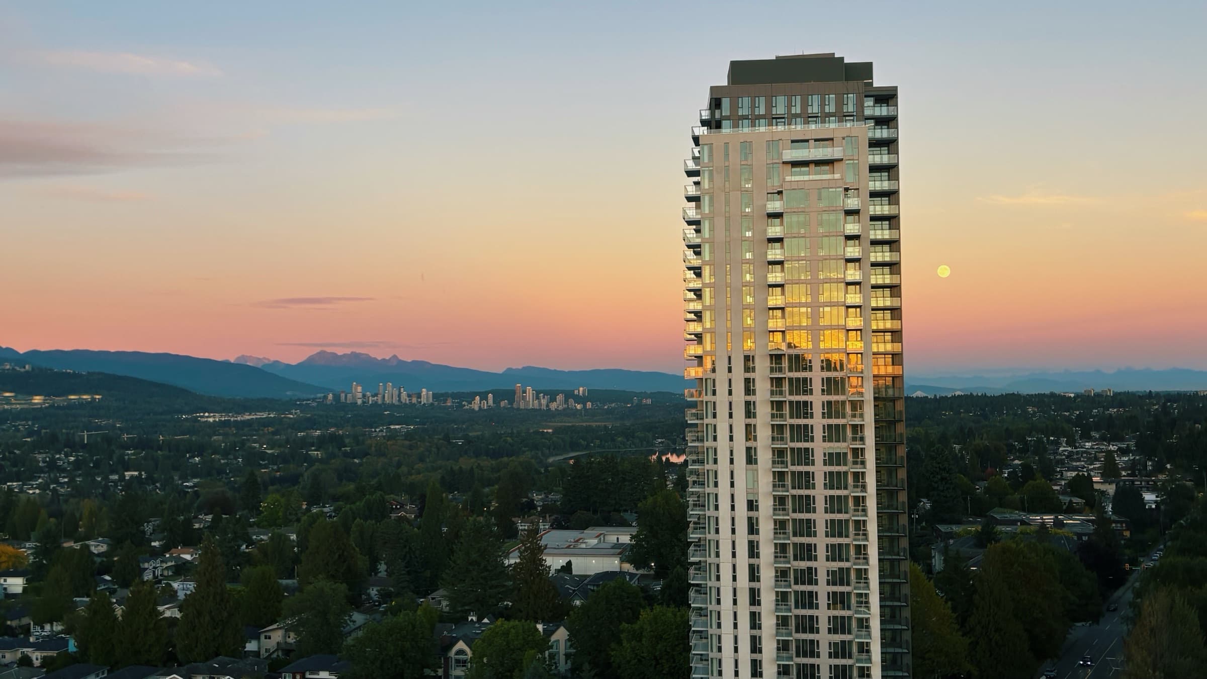 Artesia rising above the tree-lined Metrotown neighbourhood at dusk