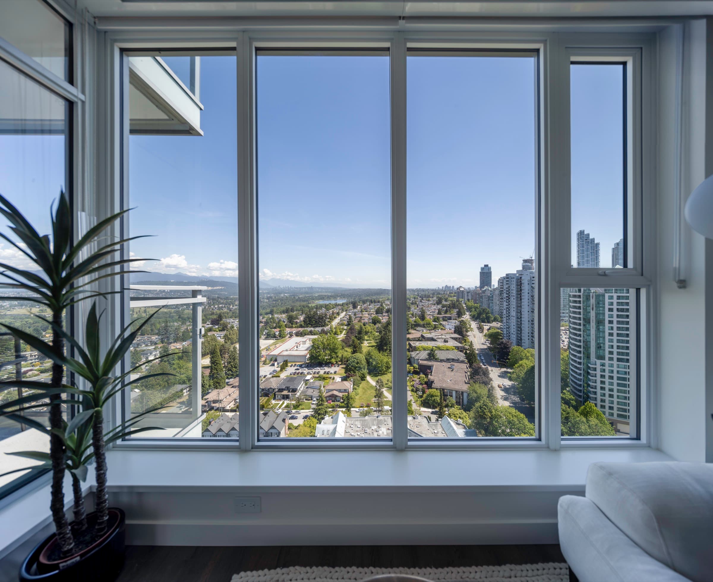 Floor-to-ceiling windows in an Artesia home looking out over Metrotown